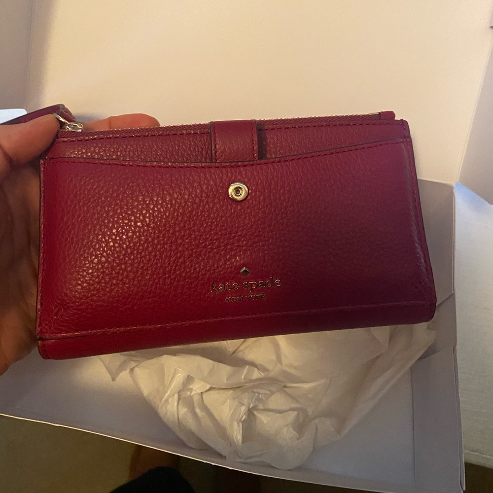 BRAND NEW Kate Spade wristlet. Magenta colored.
